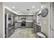 Well-lit kitchen with stainless steel appliances, wooden countertops, and gray cabinets at 40866 W Sanders Way, Maricopa, AZ 85138