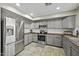 Charming kitchen featuring stainless steel appliances and wood-look countertops at 40866 W Sanders Way, Maricopa, AZ 85138