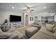 Open-concept living room featuring neutral colored couches and earth-tone flooring at 40866 W Sanders Way, Maricopa, AZ 85138