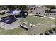 Aerial view of a playground with swings, picnic tables, a shaded structure, and sand areas at 40866 W Sanders Way, Maricopa, AZ 85138
