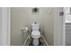 Compact powder room featuring neutral paint, wall storage, and tile flooring at 40866 W Sanders Way, Maricopa, AZ 85138