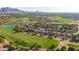 Sprawling community from an aerial view showcasing golf course, serene lakes, and beautiful mountain views at 4455 E Palmdale Ln, Gilbert, AZ 85298