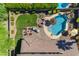 Aerial view of backyard featuring a pool, fire pit, lounge chairs and lush landscaping and mature hedges for privacy at 4455 E Palmdale Ln, Gilbert, AZ 85298