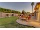 Large backyard with a built-in BBQ and a cozy fire pit, creating the perfect space for outdoor living at 4455 E Palmdale Ln, Gilbert, AZ 85298