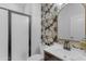 Stylish half bathroom featuring modern fixtures, decorative wallpaper, and a sleek vanity sink at 4455 E Palmdale Ln, Gilbert, AZ 85298