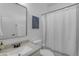 Clean bathroom featuring a shower with a decorative curtain and a mirror above the sink at 4455 E Palmdale Ln, Gilbert, AZ 85298