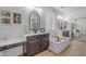 Bright bathroom with double vanity sinks, soaking tub, and stylish decor, creating a spa-like atmosphere at 4455 E Palmdale Ln, Gilbert, AZ 85298