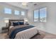 Bright bedroom with neutral decor features plush bedding, side tables with lamps, and natural light from multiple windows at 4455 E Palmdale Ln, Gilbert, AZ 85298