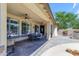 Inviting covered patio featuring ceiling fans, stone floors, and an outdoor kitchen, perfect for entertaining at 4455 E Palmdale Ln, Gilbert, AZ 85298