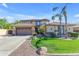 Inviting two-story home featuring a well-manicured lawn, desert landscaping, and attached two-car garage at 4455 E Palmdale Ln, Gilbert, AZ 85298