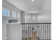 Bright foyer with natural light, decorative railing, and view of the lower level, creating a welcoming entrance at 4455 E Palmdale Ln, Gilbert, AZ 85298