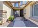 Inviting front entrance with a stone-accented walkway, well-maintained landscaping, and a cozy bench by the front door at 4455 E Palmdale Ln, Gilbert, AZ 85298