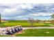 Picturesque golf course view with a row of golf carts parked beside manicured green lawns against a backdrop of distant mountains at 4455 E Palmdale Ln, Gilbert, AZ 85298