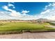 Expansive golf course view showing manicured greens, distant mountains, and a clear blue sky perfect for a relaxing day on the links at 4455 E Palmdale Ln, Gilbert, AZ 85298