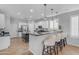 Kitchen showcasing an island with bar seating, stainless steel appliances, and modern fixtures at 4455 E Palmdale Ln, Gilbert, AZ 85298