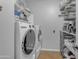 Laundry room featuring a stacked washer and dryer, plus shelving and storage space at 4455 E Palmdale Ln, Gilbert, AZ 85298