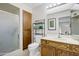 Bright bathroom featuring a glass door shower, wooden cabinets and shelving for storing towels and toiletries at 4734 E Florian Cir, Mesa, AZ 85206