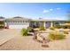 Attractive front exterior with xeriscaping, a two-car garage, and an arched window with decorative wreath at 4734 E Florian Cir, Mesa, AZ 85206