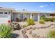 Charming single-story home with brick accents, desert landscaping and inviting front sitting area at 4734 E Florian Cir, Mesa, AZ 85206