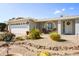 Charming front exterior with desert landscaping, a two-car garage, and a welcoming entrance with an arched window at 4734 E Florian Cir, Mesa, AZ 85206