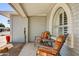Inviting front porch features an arched window and comfortable seating, creating a cozy outdoor space at 4734 E Florian Cir, Mesa, AZ 85206