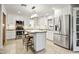 Modern kitchen with white cabinets, stainless steel appliances, and island with seating at 4734 E Florian Cir, Mesa, AZ 85206