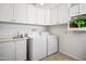 Laundry room featuring white cabinets, washer, dryer, and a sink with tiled floor at 4734 E Florian Cir, Mesa, AZ 85206