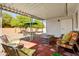 Covered patio featuring lounge seating, an umbrella-covered table and access to the backyard at 4734 E Florian Cir, Mesa, AZ 85206