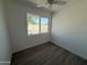Bright bedroom with a large window, neutral walls, and wood-look floors, creating a clean and peaceful space at 5024 W Osborn Rd, Phoenix, AZ 85031