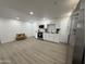 Open-concept kitchen featuring stainless steel appliances, white cabinetry, and a breakfast bar area at 5024 W Osborn Rd, Phoenix, AZ 85031