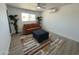Bright living area features modern rug, comfortable sofa, ottoman, and window with natural light at 5024 W Osborn Rd, Phoenix, AZ 85031