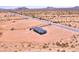 Scenic aerial view of a desert home with long driveway access to a nearby road at 50426 W Wildwood Rd, Maricopa, AZ 85139