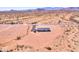 Serene aerial shot featuring a desert home, a well, and a picturesque mountain backdrop at 50426 W Wildwood Rd, Maricopa, AZ 85139