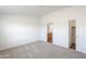 Inviting bedroom with neutral carpeting, a walk-in closet, and attached bathroom for added convenience at 50426 W Wildwood Rd, Maricopa, AZ 85139