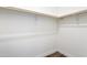 A simple walk-in closet with wood flooring and white walls is ready for custom shelving at 50426 W Wildwood Rd, Maricopa, AZ 85139