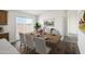 Dining room featuring a wood table, with seating for six, and sliding glass doors at 50426 W Wildwood Rd, Maricopa, AZ 85139