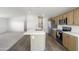 Modern kitchen showcasing quartz countertops, stainless appliances, and an open, airy layout at 50426 W Wildwood Rd, Maricopa, AZ 85139