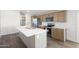 Modern kitchen showcasing quartz countertops, an island sink, and stainless steel appliances at 50426 W Wildwood Rd, Maricopa, AZ 85139