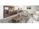 Inviting living room showcases an open concept to the kitchen with modern finishes and stainless steel appliances at 50426 W Wildwood Rd, Maricopa, AZ 85139