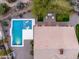 Aerial view of backyard oasis with pool, lounge chairs, an outdoor kitchen, and desert landscaping at 5448 E Windstone Trl, Cave Creek, AZ 85331