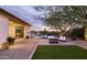 Charming backyard featuring a covered patio, lush lawn, and a sparkling pool at 5448 E Windstone Trl, Cave Creek, AZ 85331