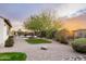 Backyard has desert landscaping, artificial turf, shade trees, and an outdoor seating area at 5448 E Windstone Trl, Cave Creek, AZ 85331