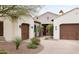 Charming home featuring a three-car garage, desert landscaping and a paved driveway at 5448 E Windstone Trl, Cave Creek, AZ 85331
