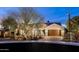 Beautiful home featuring a three-car garage and desert landscaping at dusk at 5448 E Windstone Trl, Cave Creek, AZ 85331