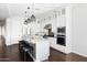 Modern kitchen with white cabinets, stainless steel appliances, and a large central island at 5448 E Windstone Trl, Cave Creek, AZ 85331