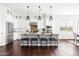 Bright kitchen with stainless steel appliances, an island with seating, and modern pendant lighting at 5448 E Windstone Trl, Cave Creek, AZ 85331