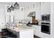 Modern kitchen with stainless steel appliances, granite countertops, and white cabinetry at 5448 E Windstone Trl, Cave Creek, AZ 85331
