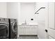 Convenient laundry room includes washer, dryer, sink, and storage at 5448 E Windstone Trl, Cave Creek, AZ 85331