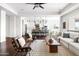 Airy living room showcasing an open floor plan with stylish furnishings, a kitchen view, and hardwood floors at 5448 E Windstone Trl, Cave Creek, AZ 85331