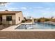 Backyard pool with in-pool lounge chairs, an umbrella, desert landscaping, and backyard fencing at 5448 E Windstone Trl, Cave Creek, AZ 85331